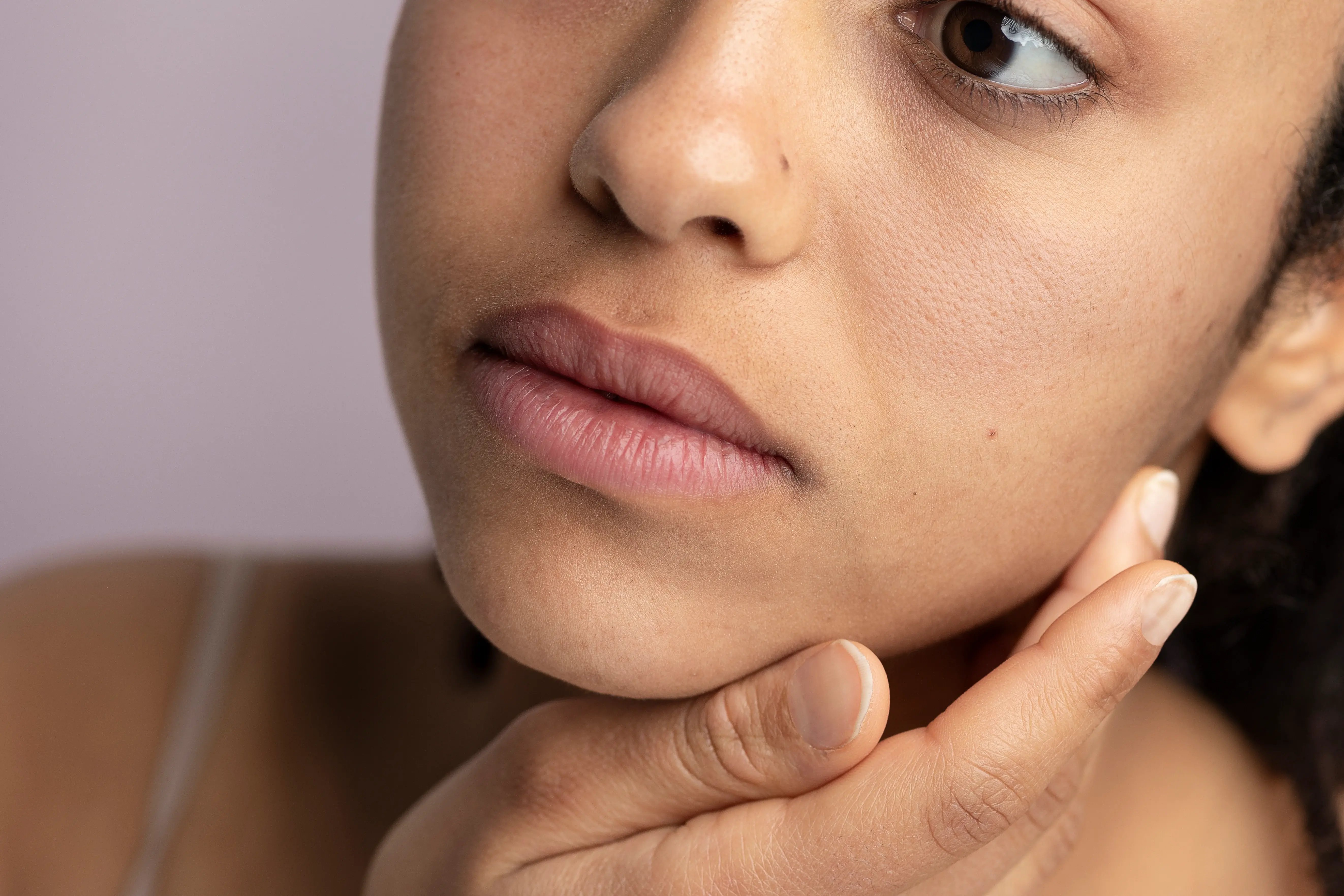 close up of concerned women looking at her uneven skin tone