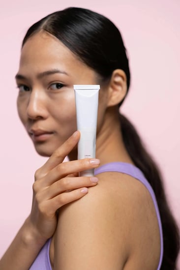 lady holding a retinol​ bottle