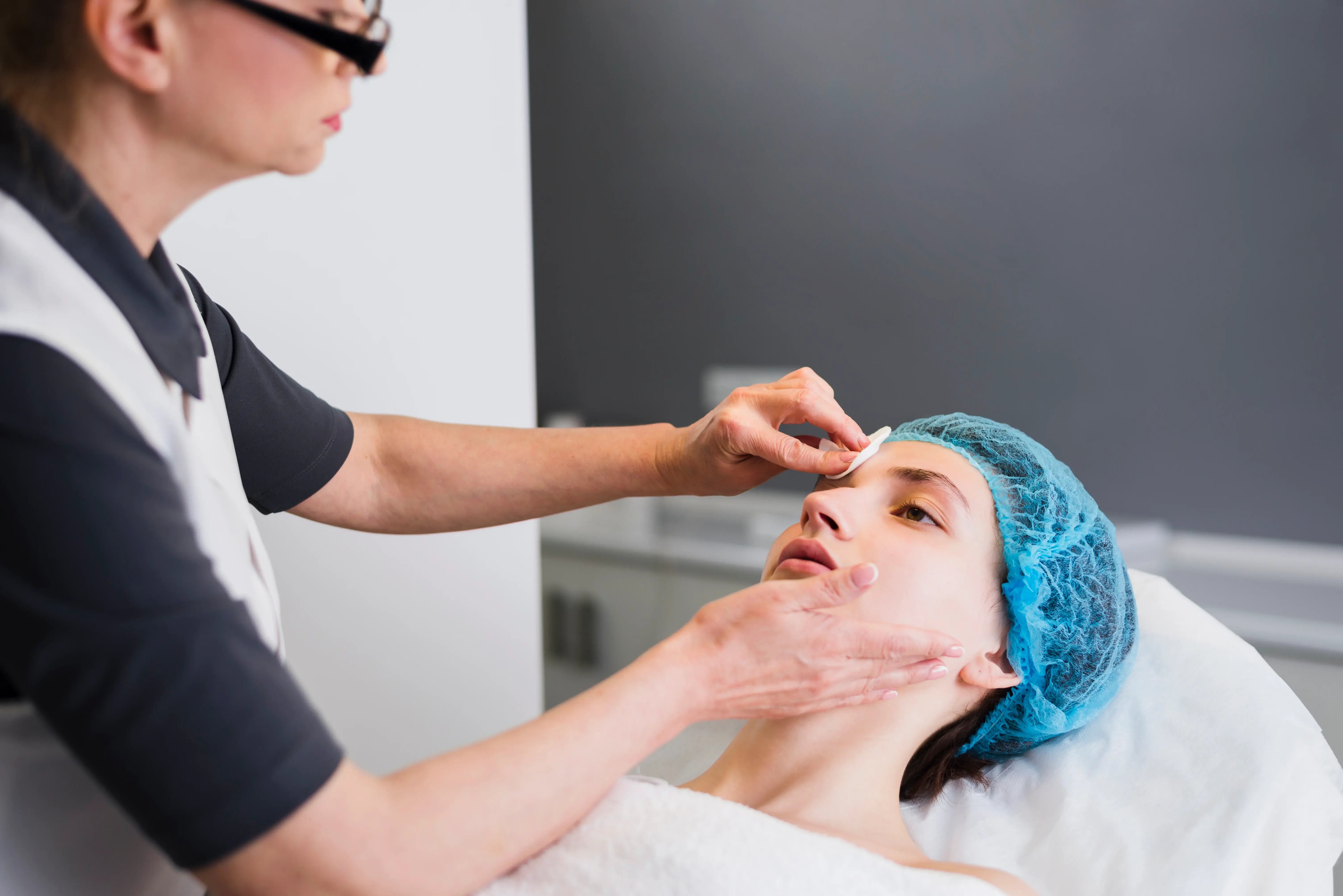 girl receiving acne scar treatment at clinic