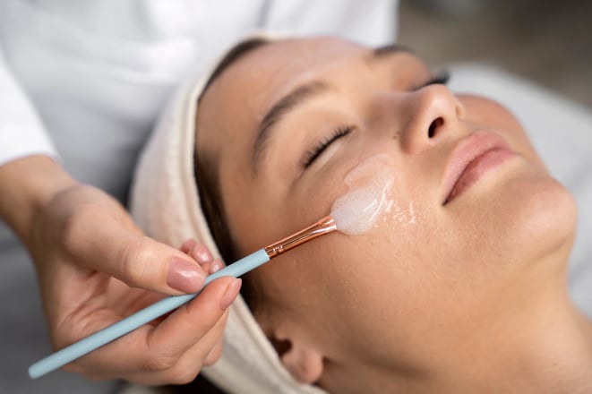 women receiving chemical peel treatment at clinic
